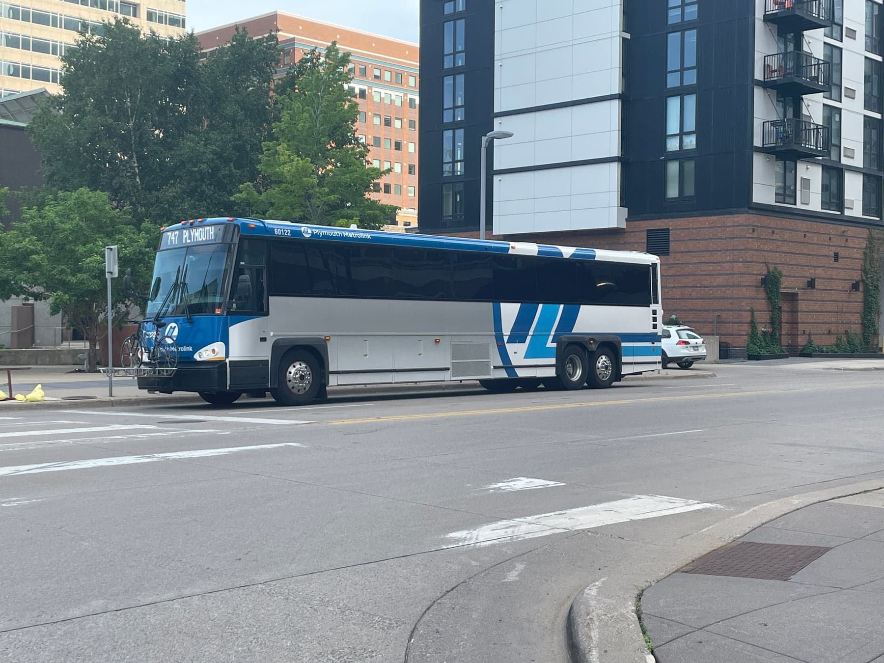 A Plymouth Metrolink coach displaying Route 747 in downtown Minneapolis at Marquette Avenue and South 11th Street, photographed in June 2023